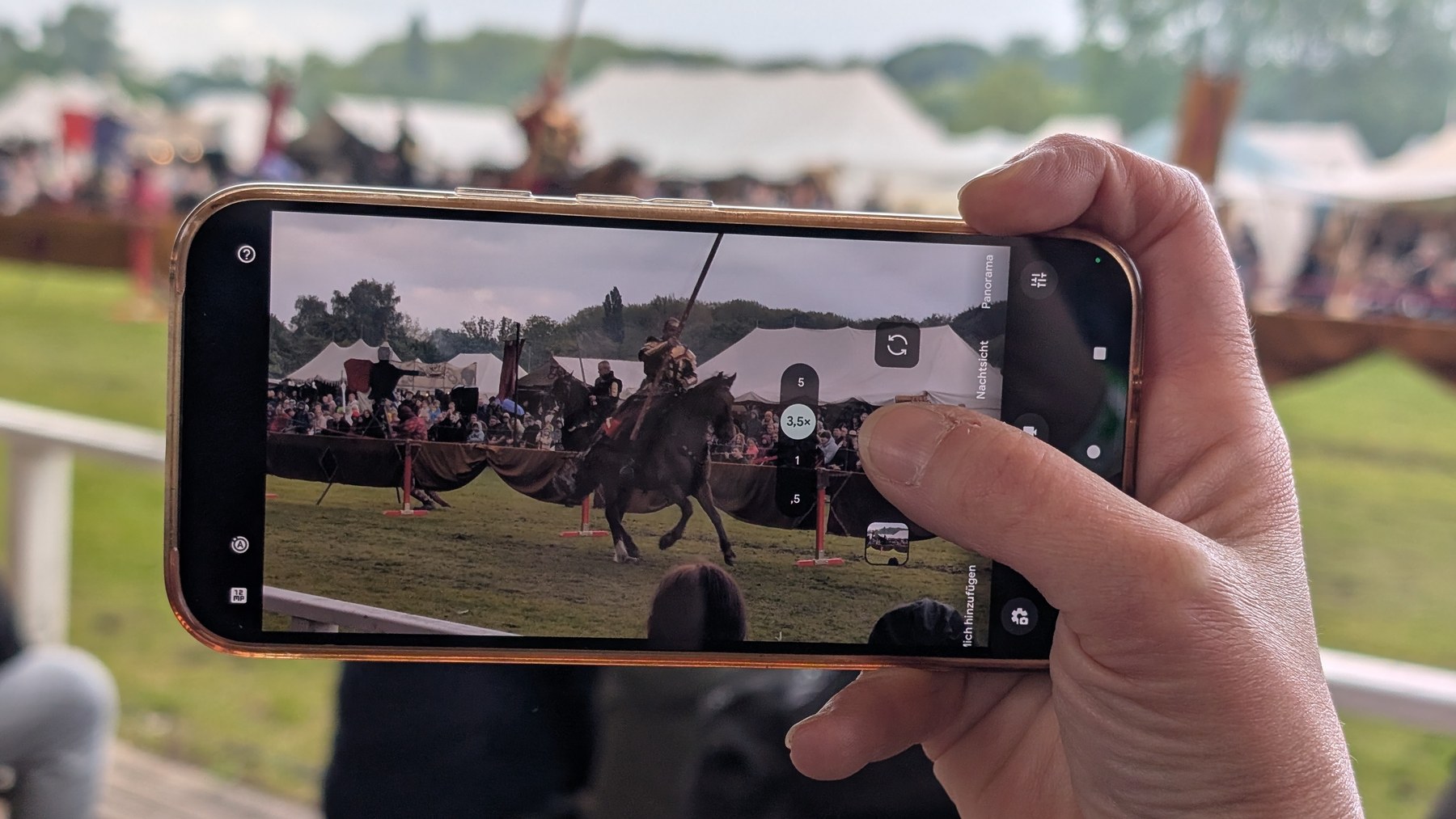 Smartphone vor einer Reitershow
